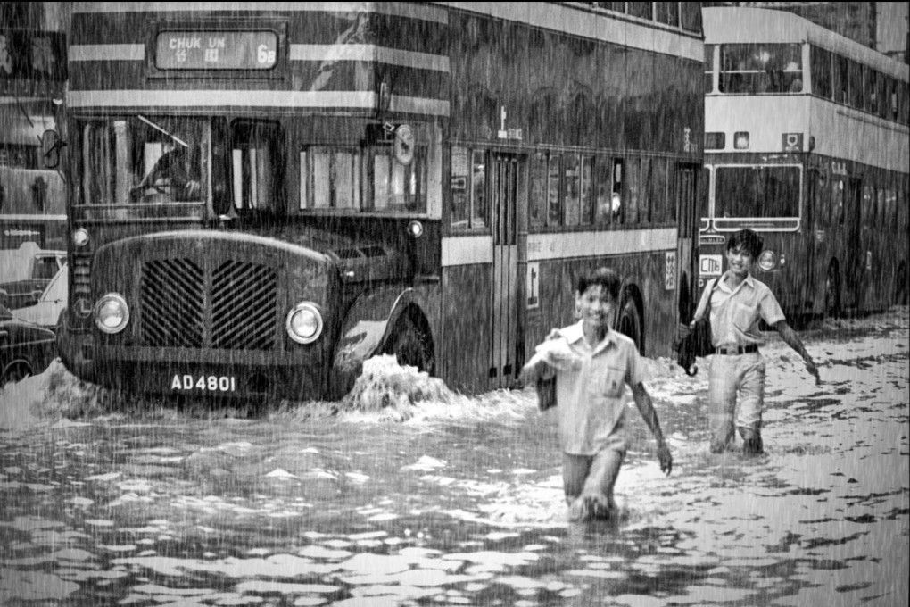 Chlidren wade through a flooded Cheung Sha Wan Road. Photo: Ho Kwok-pun/EastPro Gallery