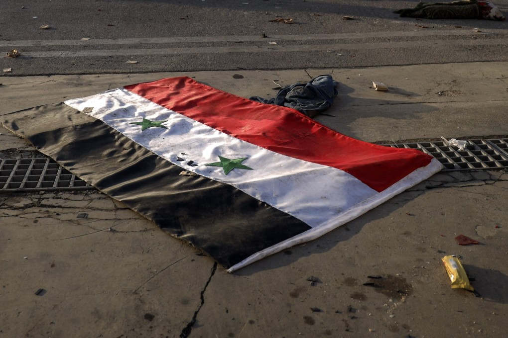 A Syrian flag lies on the tarmac of the Aleppo international airport, on December 2. Photo: AP