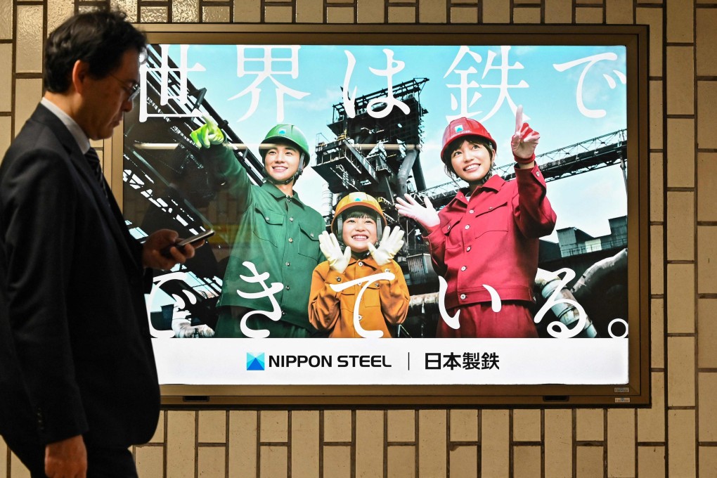 A man walks past an advertisement for Japanese steel producer Nippon Steel in Tokyo. Photo: AFP