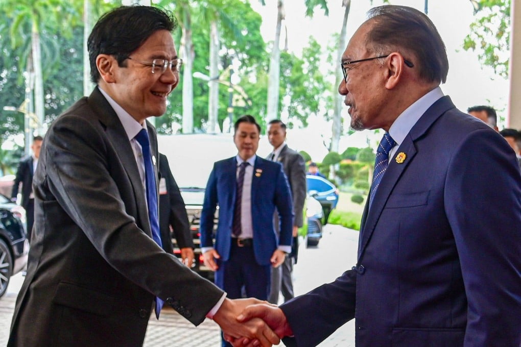 Malaysia’s Prime Minister Anwar Ibrahim (right) shakes hands with Singapore’s Prime Minister Lawrence Wong (L) before a meeting in June. Photo: Malaysia’s Department of Information / AFP