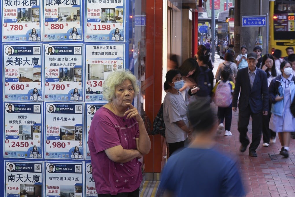 People passed a real estate agency in North Point. Photo: Eugene Lee