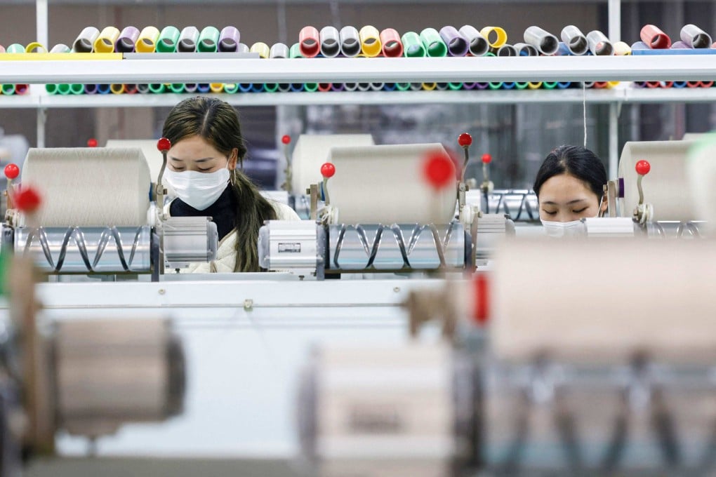 Employees work at a textile factory in Sihong in eastern China’s Jiangsu province. Photo: AFP