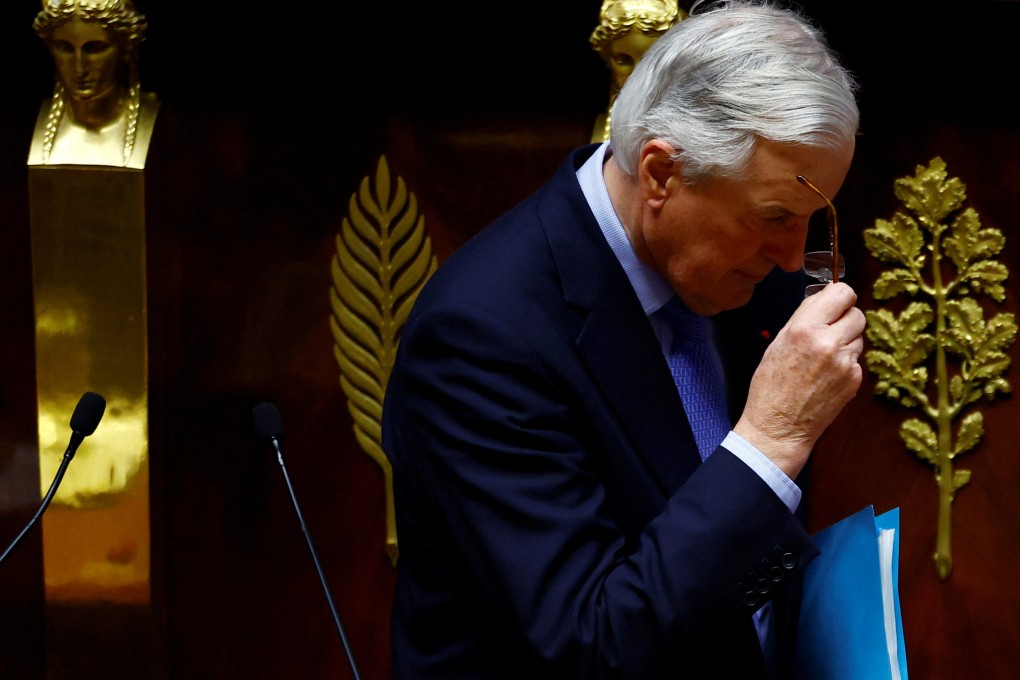 French Prime Minister Michel Barnier removes his glasses after giving a speech during a debate on two motions of no-confidence against the French government in Paris on Wednesday. Photo: Reuters