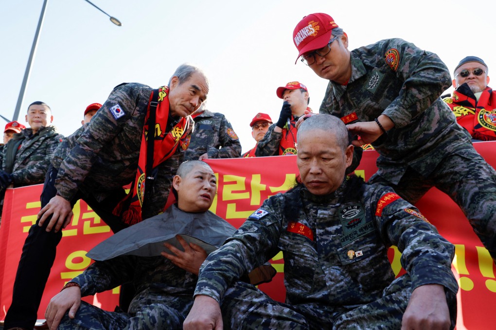 A South Korean marine veteran gets his head shaved during a Seoul rally demanding President Yoon Suk-yeol’s removal from power. Photo: Reuters