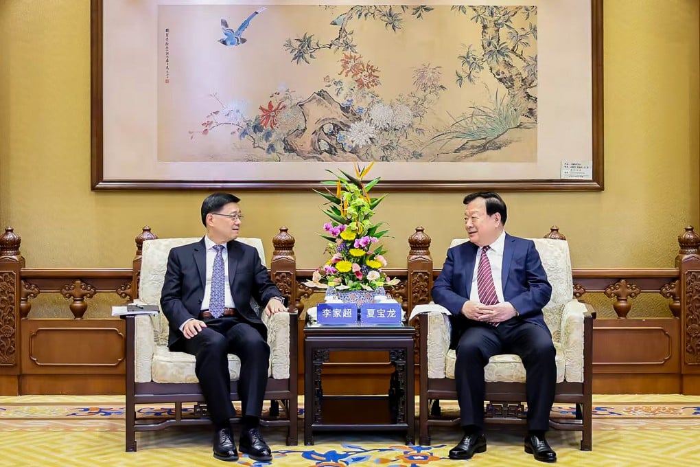 Senior Beijing official Xia Baolong (right) meets Hong Kong Chief Executive John Lee in Beijing. Photo: Hong Kong and Macau Affairs Office