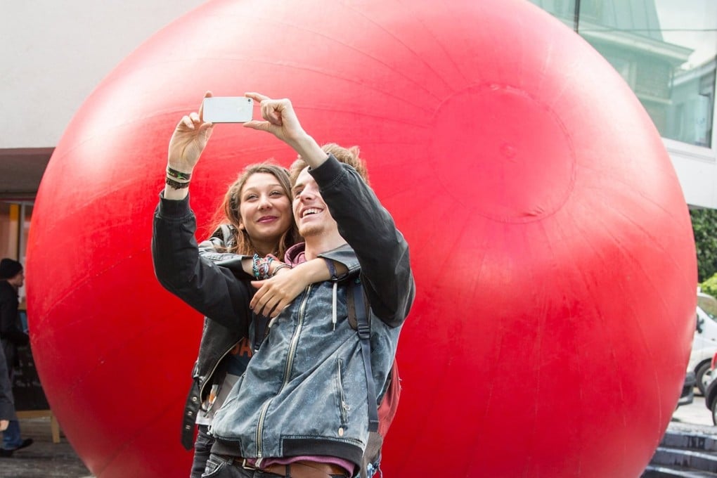 The RedBall public art installation by American artist Kurt Perschke is in Hong Kong. Photo: Brit Morgan