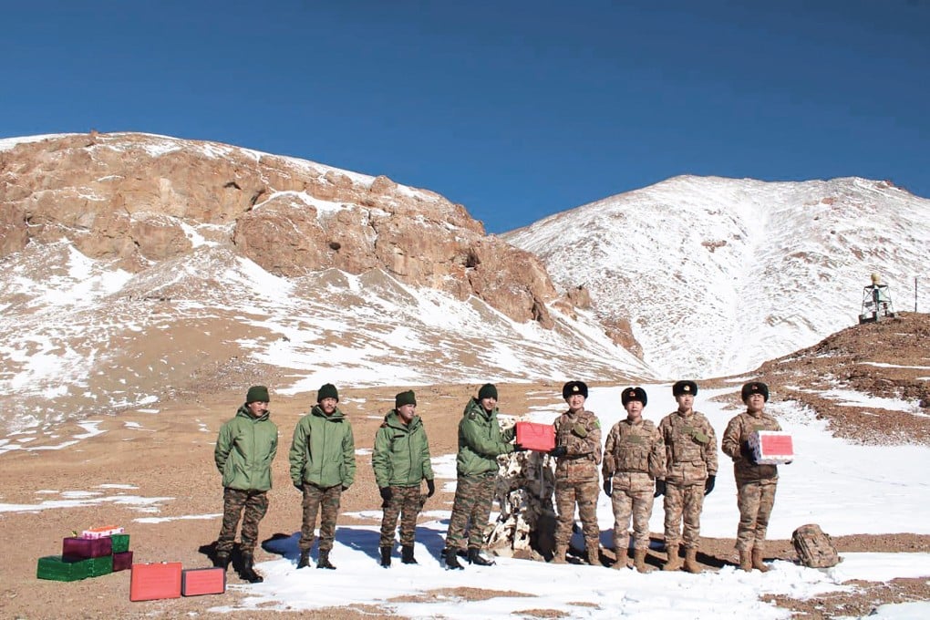 Indian and Chinese troops greet each other and exchange sweets along the Line of Actual Control in Ladakh on October 31, on the occasion of the Indian festival of Diwali. Photo: AFP
