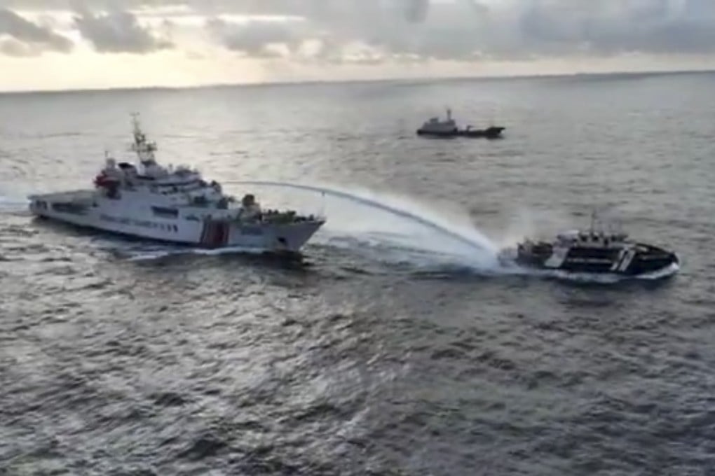 A Chinese coastguard vessel (left) fires a water cannon at a Philippine fishing vessel near a disputed shoal in the South China Sea on December 4. Photo: National Task Force for the West Philippine Sea/AP