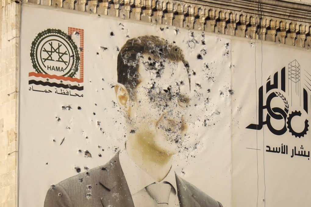 An image of Syrian President Bashar al-Assad, riddled with bullets, on the facade of a government office after the opposition’s takeover of Hama, Syria. Photo: AP