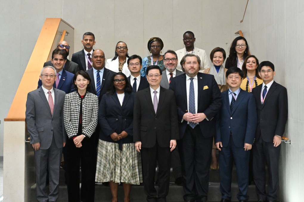 Hong Kong leader John Lee (first row, centre), meets members of a visiting delegation of overseas government officials. Photo: ISD