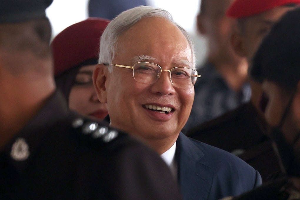 Malaysia’s former Prime Minister Najib Razak is escorted by police officers at Kuala Lumpur High Court in April. Photo: EPA-EFE