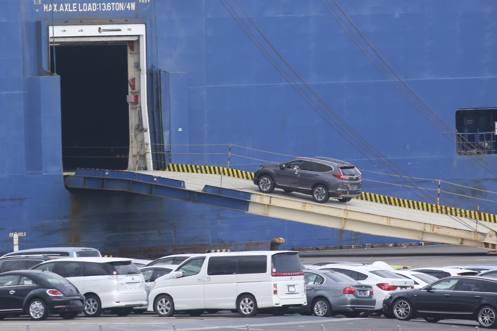 Cars for export are loaded onto a cargo ship at a port in Yokohama. Japanese exporters are working on tactics to limit the impact of Donald Trump’s “America first” policy. Photo: AP