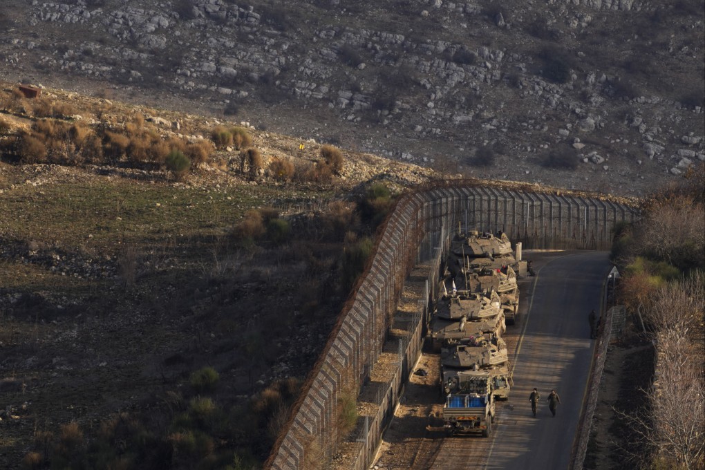 Israeli soldiers near armoured vehicles parked along the so-called Alpha Line that separates the Israeli-annexed Golan Heights from Syria. Photo: AP