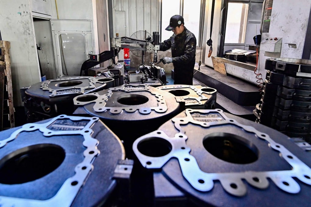 An employee works at a car parts factory in Qingzhou, Shandong province, China, on December 9. China’s car industry is an example of “involution”: overcrowding caused by an influx of financial resources and factors of production. Photo: AFP