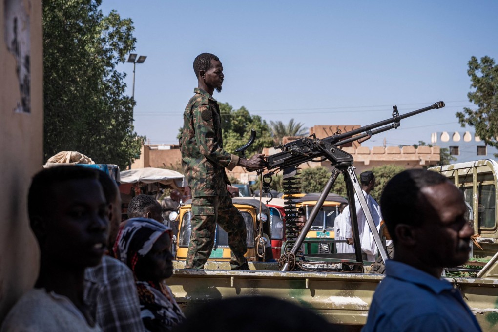 A Sudanese army soldier mans a machine gun on top of a military pickup truck outside a hospital in Omdurman on November 2. Photo: AFP
