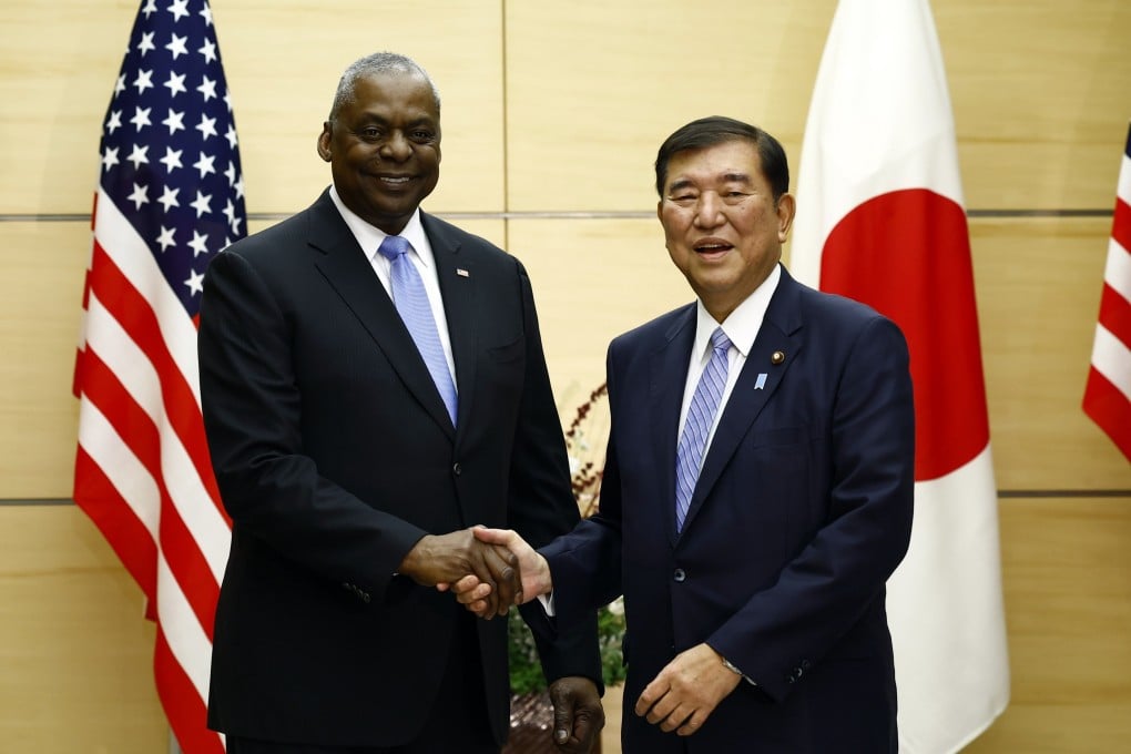US Defense Secretary Lloyd Austin (left) shakes hands with Japan’s Prime Minister Shigeru Ishiba n Tokyo, Japan on December 10. Photo: EPA-EFE/Pool