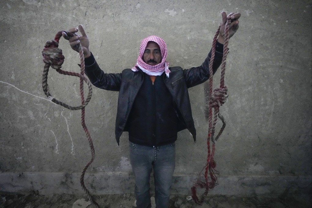 A man shows ropes tied in the shape of nooses, found in the infamous Saydnaya military prison, just north of Damascus, Syria. Photo: AP