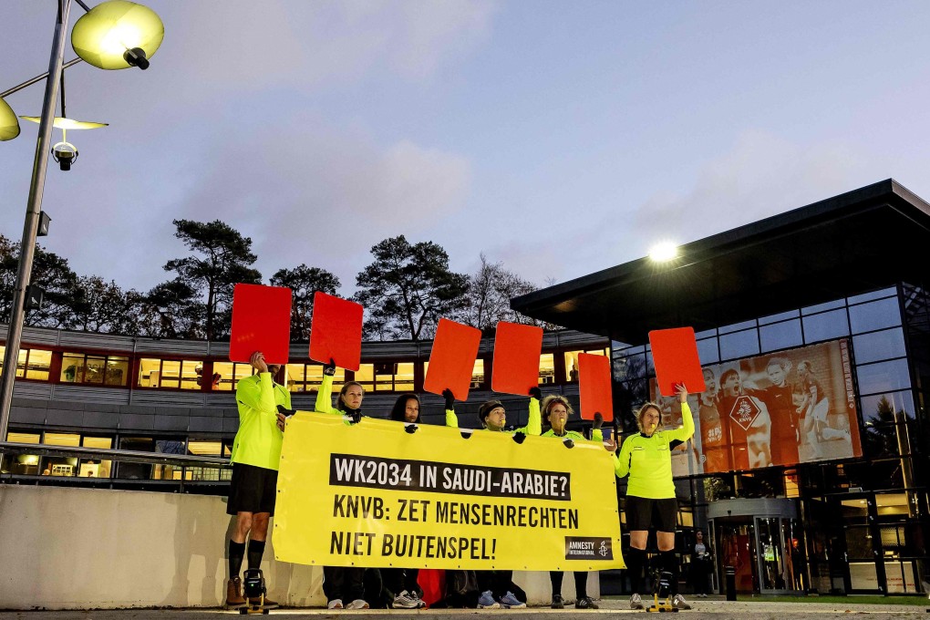 Amnesty International activists dressed as football referees holding red cards and a banner protesting against Saudi Arabia’s candidacy for the 2034 World Cup, in Zeist, Netherlands last month. Photo: AFP