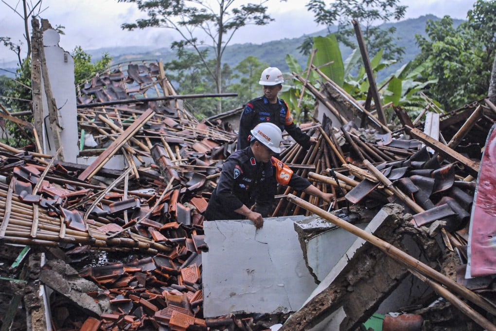 Rescuers in Sukabumi, Indonesia’s West Java province, clear up rubble on Monday from houses damaged by a landslide. Photo: AP