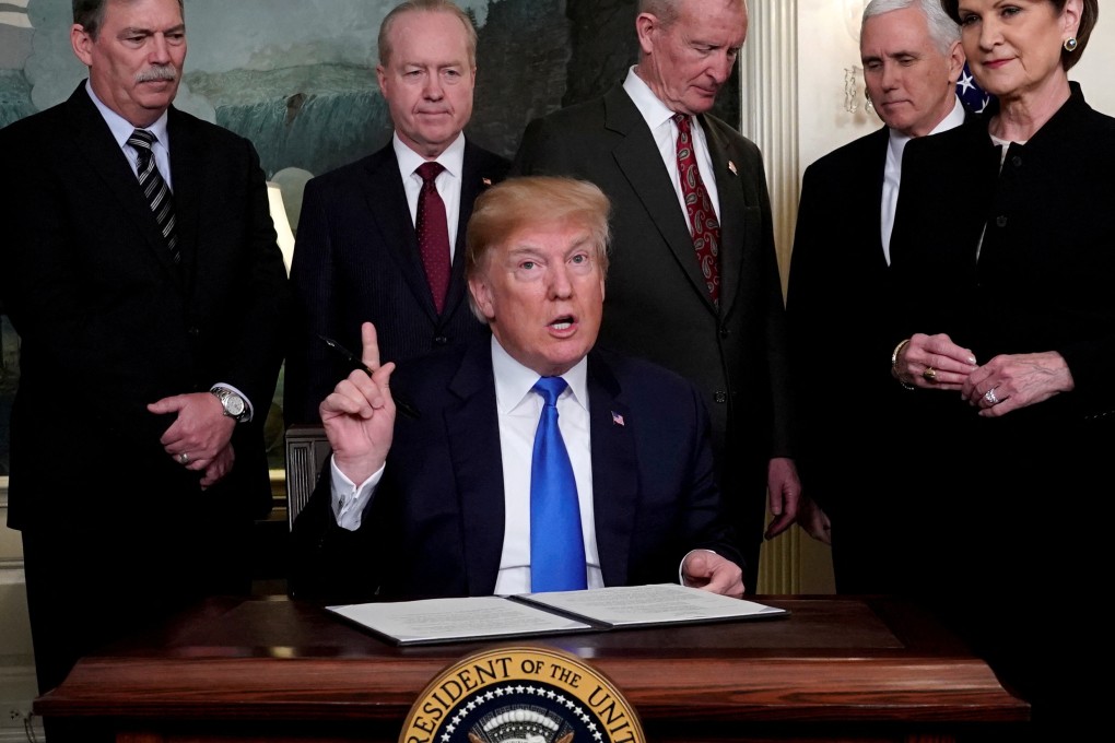 US President Donald Trump prepares to sign a memorandum on intellectual property tariffs on hi-tech goods from China at the White House in Washington on March 22, 2018. Photo: Reuters