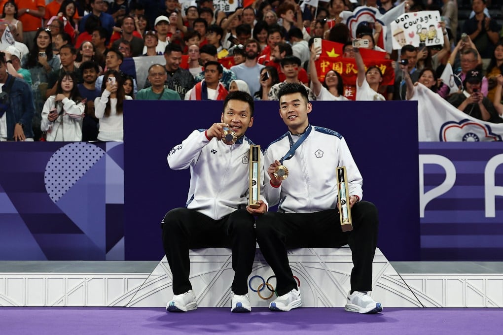 Wang Chin-lin (left) and Lee Yang show off their badminton gold medals at the Paris Olympic Games. Photo: Reuters