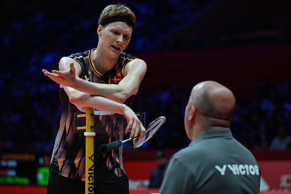 Anders Antonsen (left) talks to the referee during his men’s singles match against Li Shifeng. Photo: Xinhua