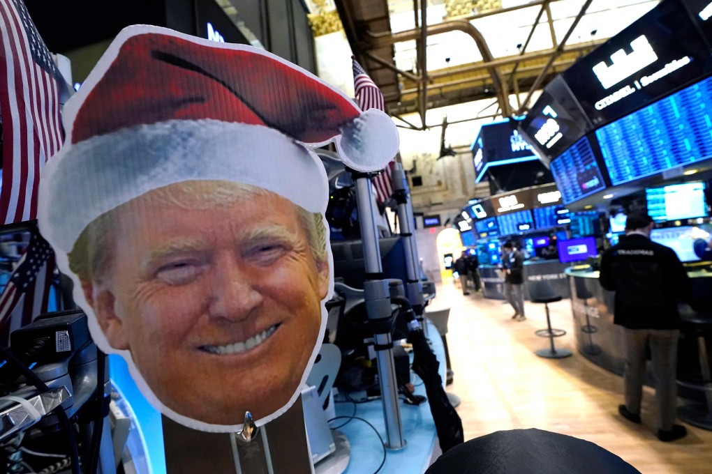 An image of US president-elect Donald Trump is displayed as traders work on the floor of the New York Stock Exchange on November 26. Photo: AFP