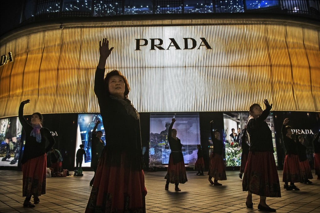 Women danced outside a Prada store in Beijing. Photo: Getty Images