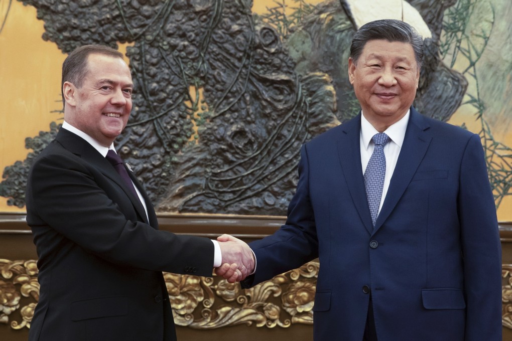 Russian Security Council deputy chairman and the head of the United Russia party Dmitry Medvedev, left, and Chinese President Xi Jinping meet in Beijing on Thursday. Photo: Sputnik Pool Photo via AP