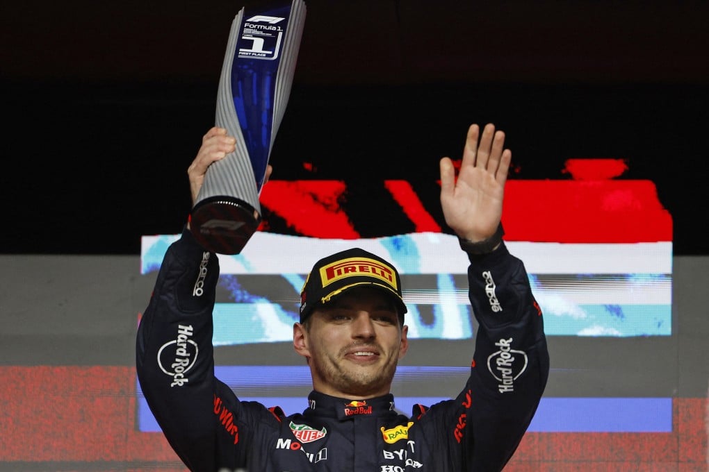 Red Bull’s Max Verstappen celebrates with a trophy on the podium after winning the Qatar Grand Prix in early December to clinch the title. Photo: Reuters