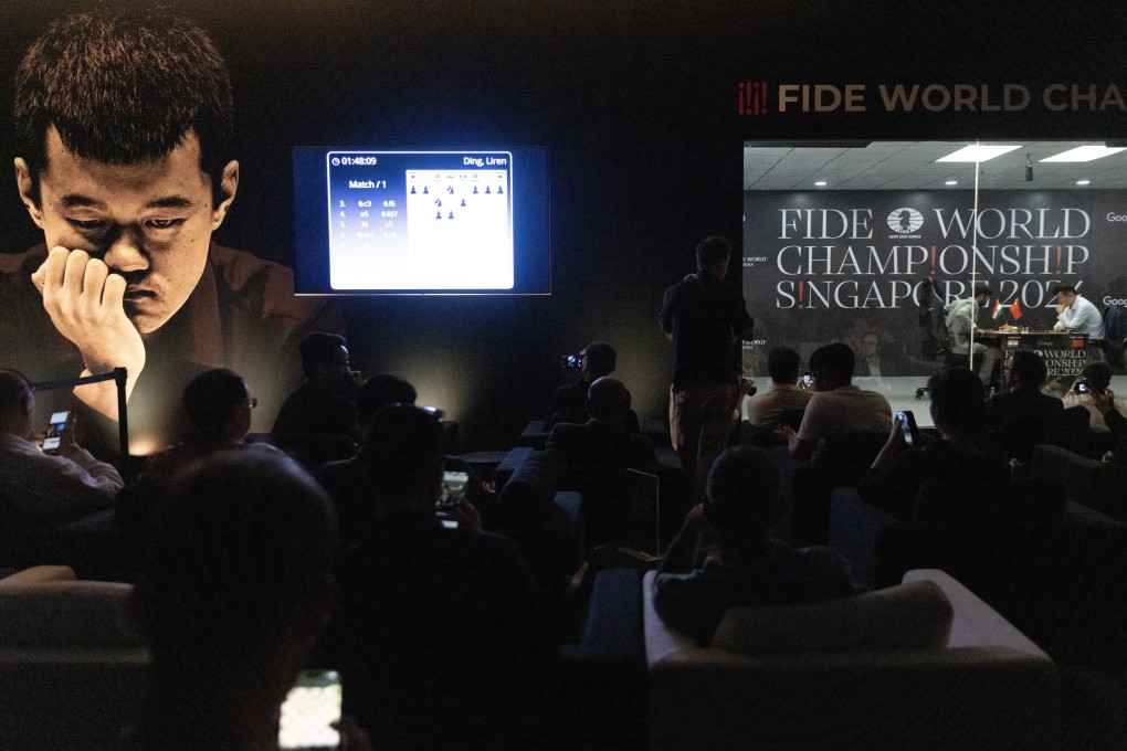 People look on in the viewing area as grandmasters Ding Liren (right) of China and Gukesh Dommaraju of India compete in the World Chess Championship in Singapore. Photo: EPA-EFE