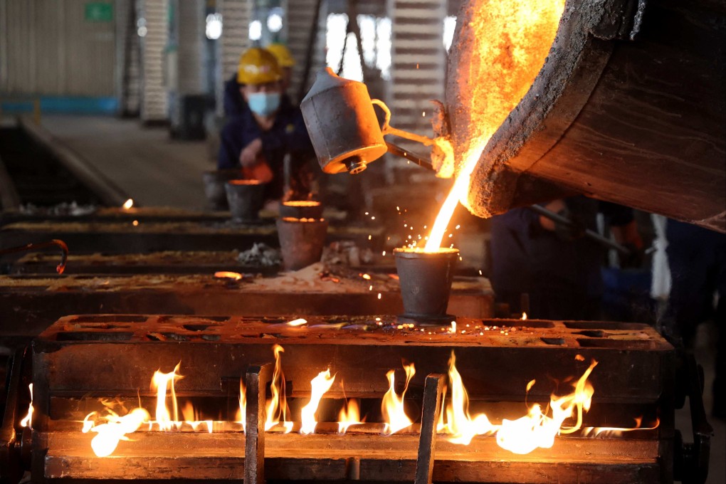 Workers pour molten steel at a factory which produces vehicle crankshafts for both the domestic market and export, in Binzhou, in eastern Shandong province, on December 10. Photo: AFP