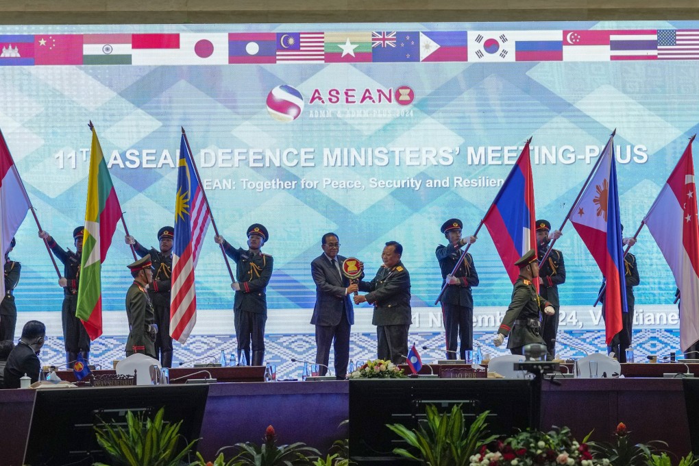 Malaysia’s Defence Minister Mohamed Khaled Nordin receives an Asean emblem at the handover of Asean chairmanship in Laos on November 21. Photo: AP