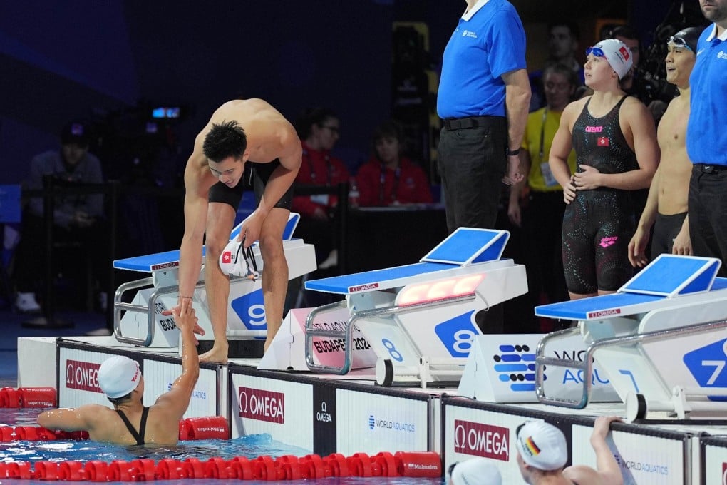 Ian Ho helps Li Sum-yiu out of the water as Siobhan Haughey and Ralph Koo check Hong Kong’s time in the mixed 4x50m freestyle relay.