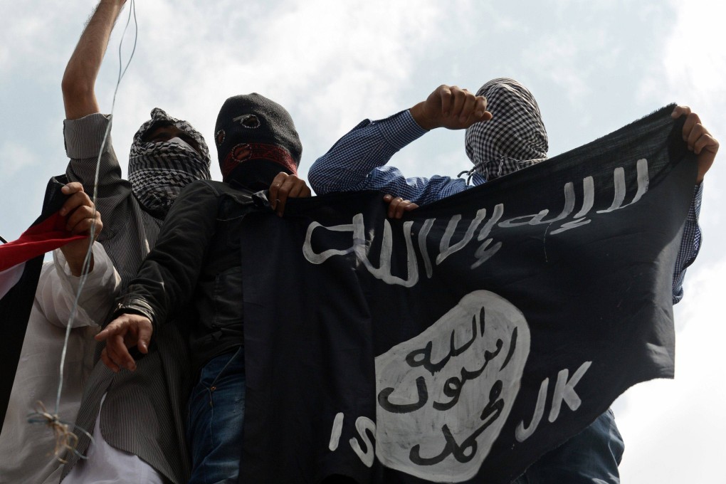 Kashmiri demonstrators hold an Islamic state flag in Srinagar, India, in 2014. Photo: AFP