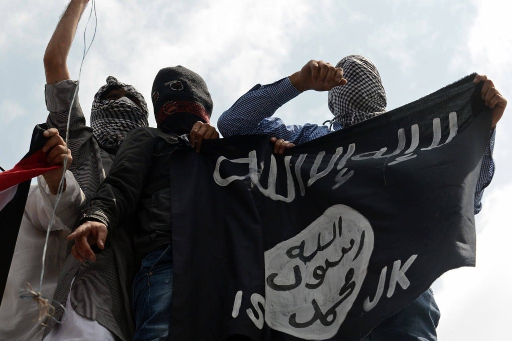 Kashmiri demonstrators hold an Islamic state flag in Srinagar, India, in 2014. Photo: AFP