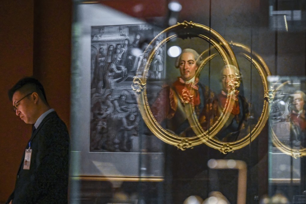 A staff member looks on during a media preview of “The Forbidden City and the Palace of Versailles” exhibition, which marks the long-standing relationship between China and France. Photo: AP