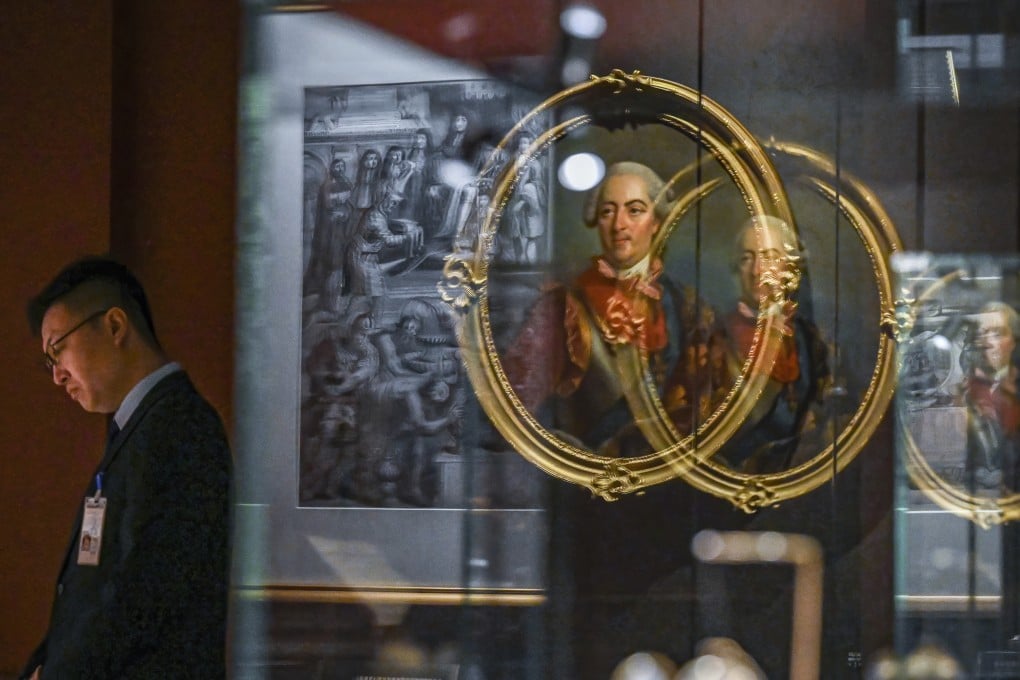 A staff member looks on during a media preview of “The Forbidden City and the Palace of Versailles” exhibition, which marks the long-standing relationship between China and France. Photo: AP