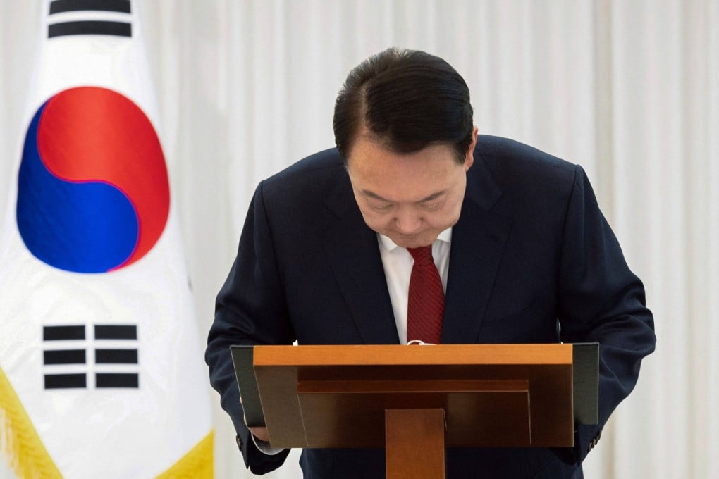 South Korean President Yoon Suk-yeol bows while giving a public address from his official residence in Seoul on Saturday. Yoon said he would “step aside” after parliament had voted to remove him from office. Photo: South Korean Presidential Office via Yonhap / AFP