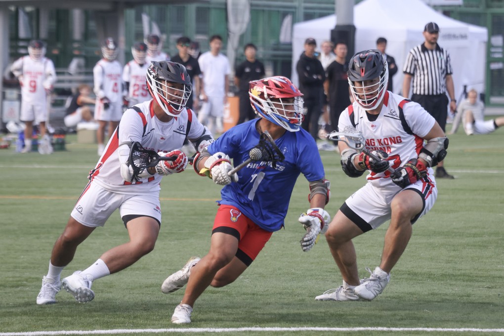 The Philippines’ Chase Ladrido (centre) is flanked by Hong Kong’s Cheung Wing (left) and Lo Tin-chiu in the Filipinos’ 20-8 win at Wong Chuk Hang Sports Ground on Saturday. Photo: Jonathan Wong