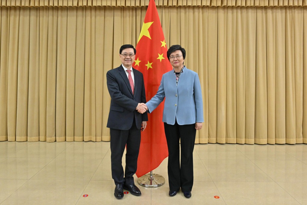 Chief Executive John Lee (left) with the country’s human resources and social security minister, Wang Xiaoping, during a meeting on Saturday in Beijing. Photo: Handout
