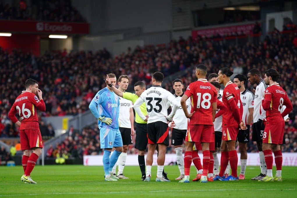 Liverpool were reduced to 10 men early during their clash with Fulham as Andy Robertson (left) was given his marching orders for preventing a goalscoring opportunity. Photo: dpa