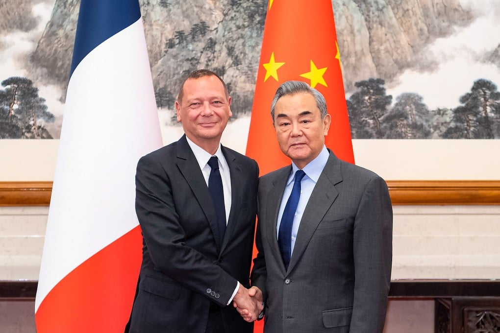 Chinese Foreign Minister Wang Yi (right) meets Emmanuel Bonne, diplomatic adviser to the French president, in Beijing on Saturday. Photo: Xinhua