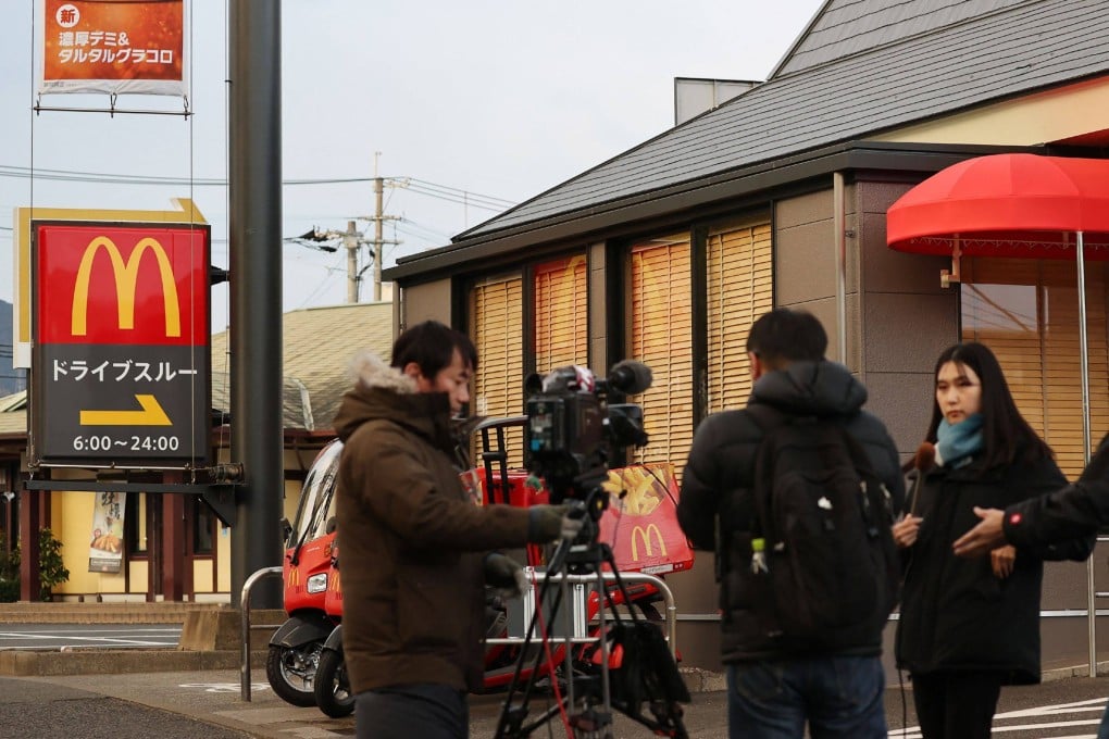 Reporters gather in front of the McDonald’s branch in Kitakyushu city, Fukuoka prefecture, where a schoolgirl was stabbed to death. Photo: Jiji Press/AFP