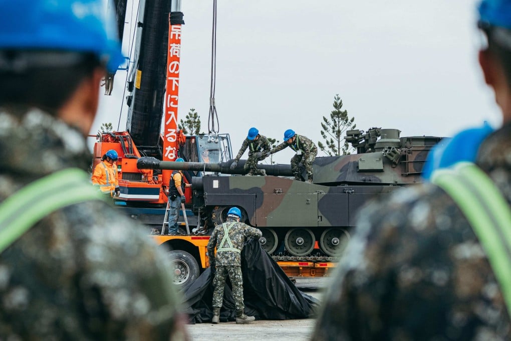 Taiwanese soldiers secure a US-made Abrams battle tank onto a trailer in Hsinchu county, Taiwan on Monday. Photo: AFP / Taiwan’s Ministry of National Defence