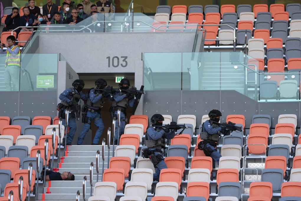 Officers storm the 5,000-seat stadium as part of the drill. Photo: Sam Tsang