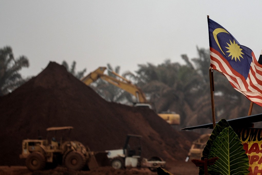 A Malaysian flag flies at the entry-point to a mining site in rural Pahang state in 2015. Photo: AFP