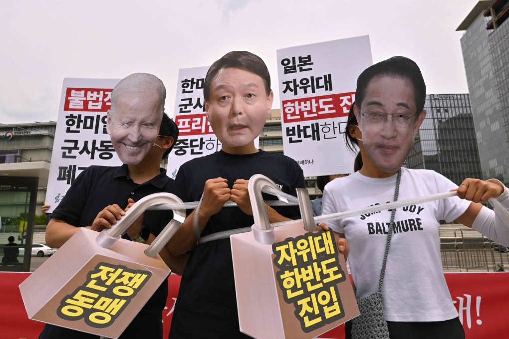 South Korean protesters wear masks of President Yoon Suk-yeol (centre), US President Joe Biden and then Japanese prime minister Fumio Kishida as they demonstrate against a trilateral military exercise in front of the US embassy in Seoul on June 27. Photo: AFP