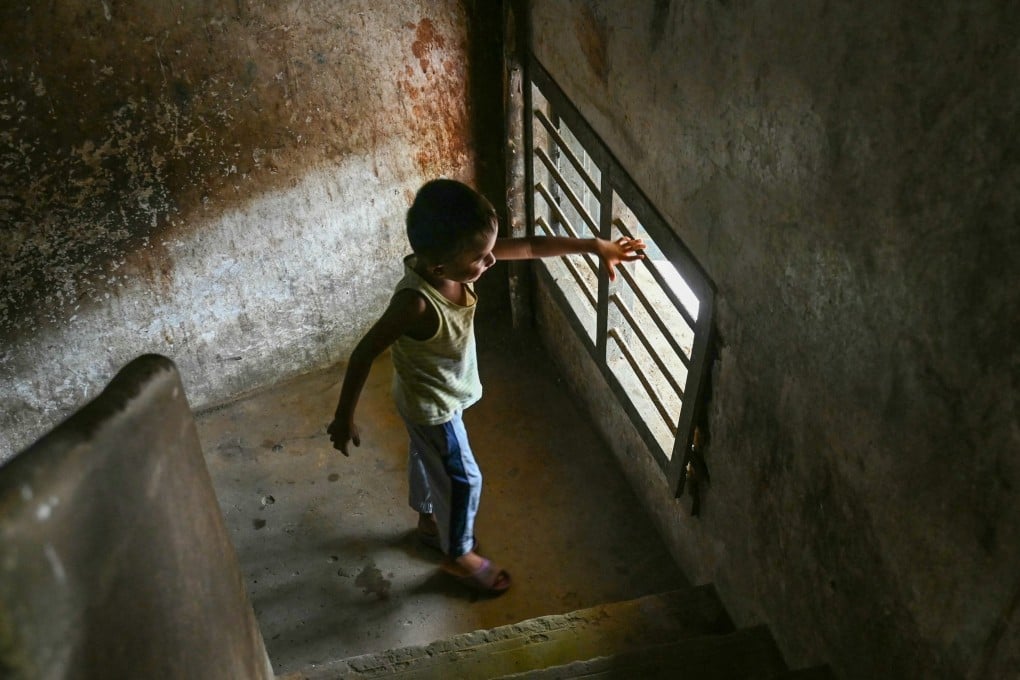 A Rohingya refugee child looks out through the bars of a window at a camp on the outskirts of Chennai, India. Photo: AFP