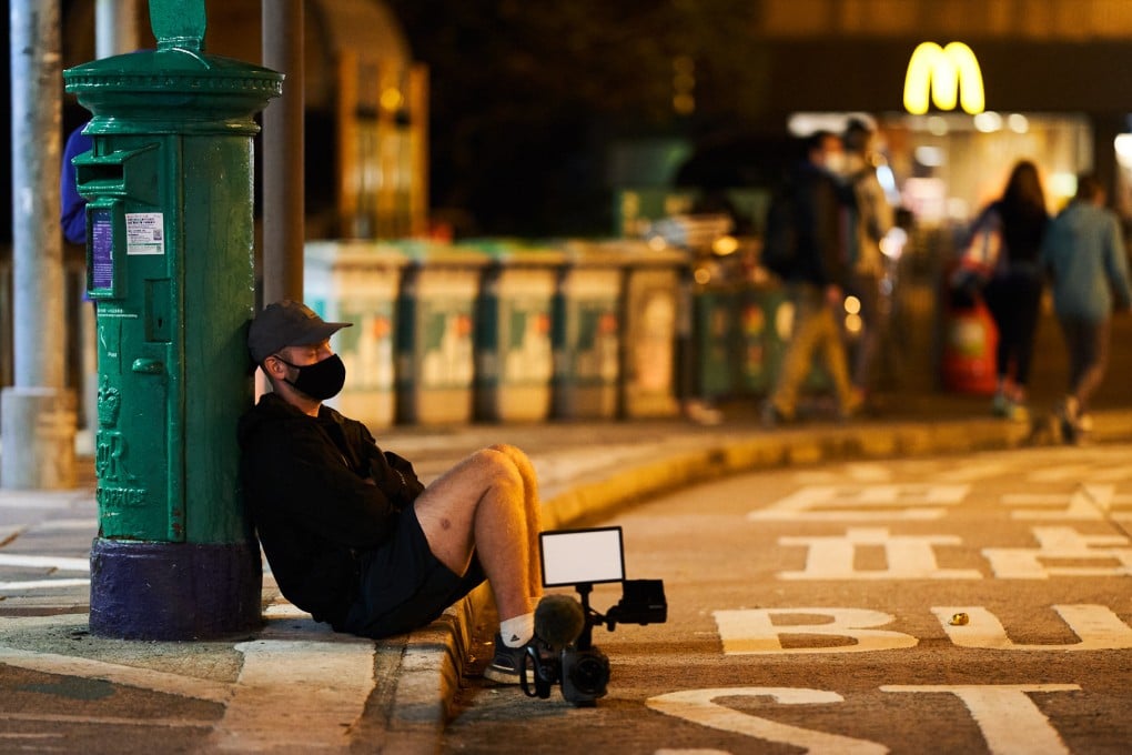 Four Trails director Robin Lee rests against a post box by the Mui Wo Ferry Pier in a still from the documentary about the 2021 Hong Kong Four Trails Ultra Challenge. Photo: Edko Films